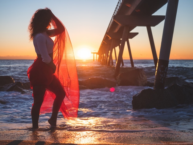 Belle Fille En Robe Rouge Sur La Plage Au Lever Du Soleil