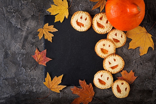 Biscuits Maison Sous La Forme De Citrouilles D'halloween Jack-o-lantern Sur La Table Sombre. Vue De Dessus. Photo gratuit