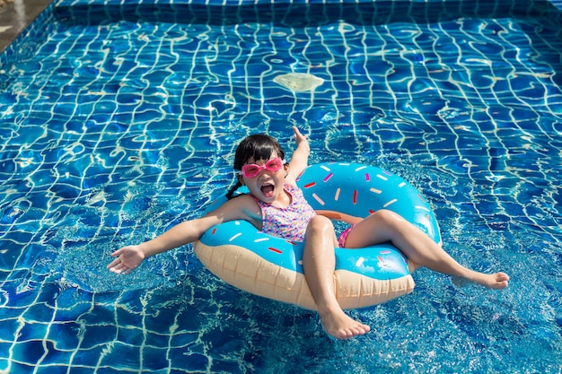 Drole Petite Asiat Jouant Avec Anneau Gonflable Colore Dans La Piscine En Plein Air Par Une Chaude Journee D Ete Photo Premium