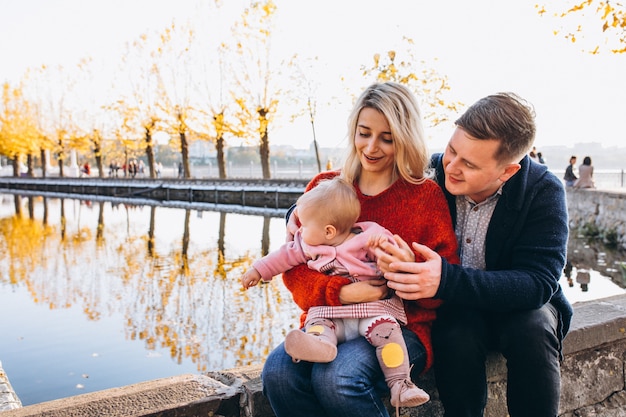 Famille avec bébé fille marchant dans le parc Photo gratuit
