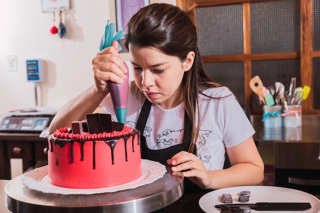 Femme De Decoration De Gateau Au Chocolat Dans La Cuisine Photo Premium