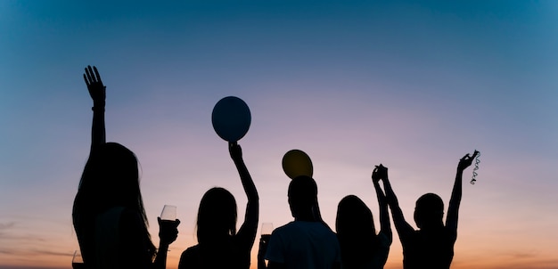 Gens qui dansent à la fête sur le toit à l'aube Photo gratuit