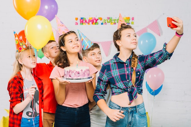 Groupe D Amis Avec Un Gateau D Anniversaire Prenant Selfie Sur Telephone Portable Photo Gratuite