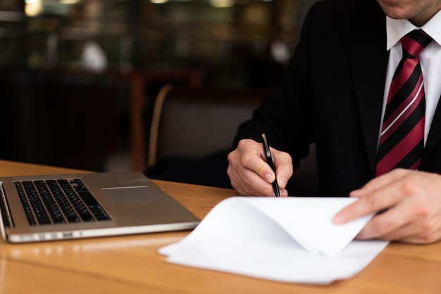 Homme au bureau écrit sur papier Photo gratuit