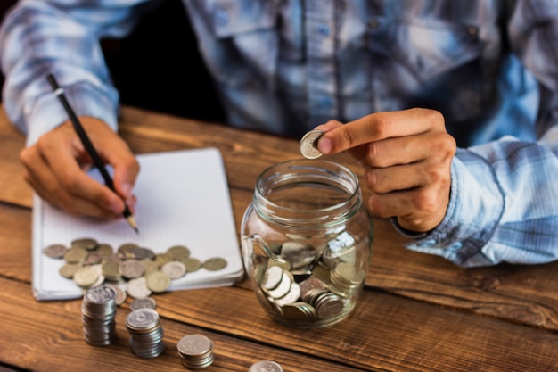 Homme grand angle calculant les économies Photo gratuit