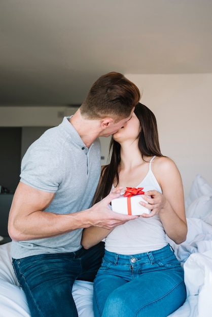 Homme Sembrasser Et Donner Une Boîte Cadeau à Une Femme Photo Gratuite