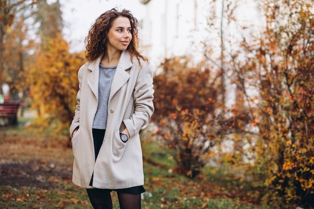 Jeune femme aux cheveux bouclés dans le parc Photo gratuit