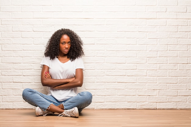 Jeune Femme Noire Assise Sur Un Plancher En Bois Très En Colère Et