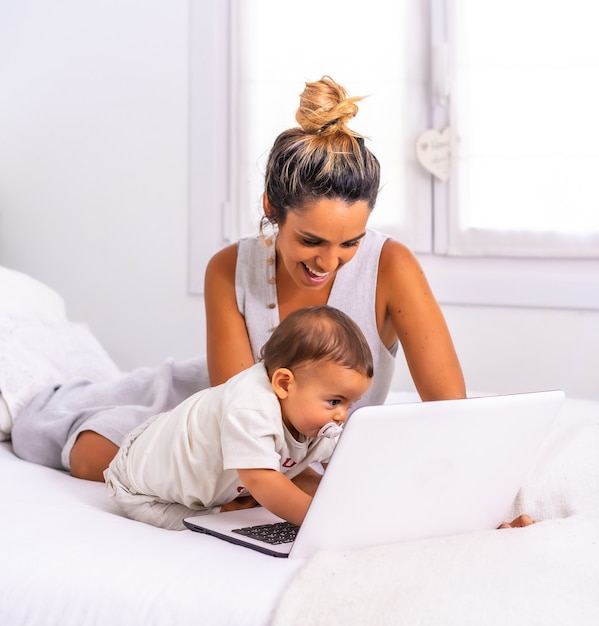 Jeune Mère Avec Son Fils Dans La Chambre Au Dessus Du Lit Faisant Un Appel Vidéo Photo Premium 