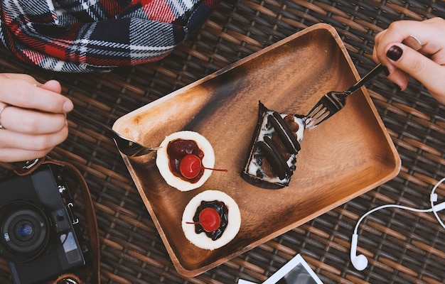 Mains tenir fourches manger des gâteaux sucrés Photo gratuit