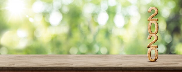 Numéro de bois du nouvel an 2020 sur une table en bois au flou abstrait bannière verte Photo Premium