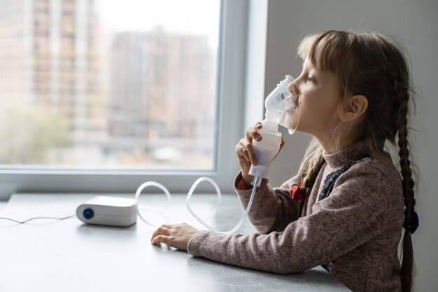 Petite Fille Faisant L Inhalation Avec Nebuliseur A La Maison Enfant Nebuliseur D Inhalateur D Asthme Photo Premium