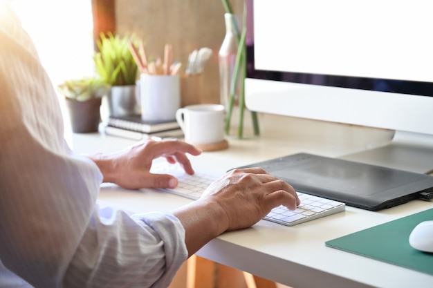 Pigiste designer travaillant avec un ordinateur et une tablette numérique Photo Premium