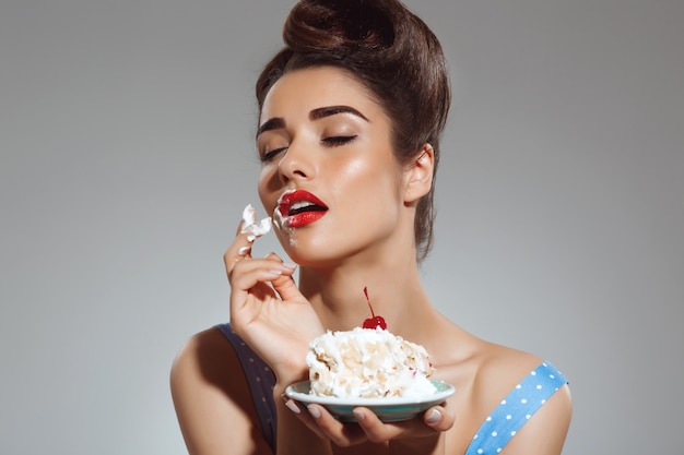 Portrait De Beau Pin Up Femme Mange Gateau Photo Gratuite