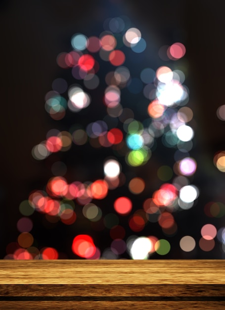 Table en bois 3d donnant sur un arbre de noël défocalisé Photo gratuit