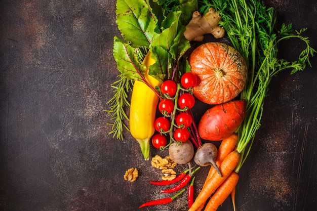 Table de légumes d'automne. citrouille, courgettes, patates douces, carottes et betteraves sur une table sombre. Photo Premium