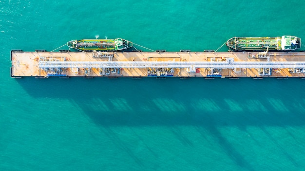 Vue aérienne de déchargement de navire-citerne au port, entreprise d'import d'import-export de pétrole avec des hydrocarbures de transport de navire-citerne de raffinerie en mer. Photo Premium