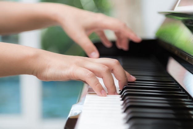 Vue latérale des mains de femme jouant du piano Photo gratuit