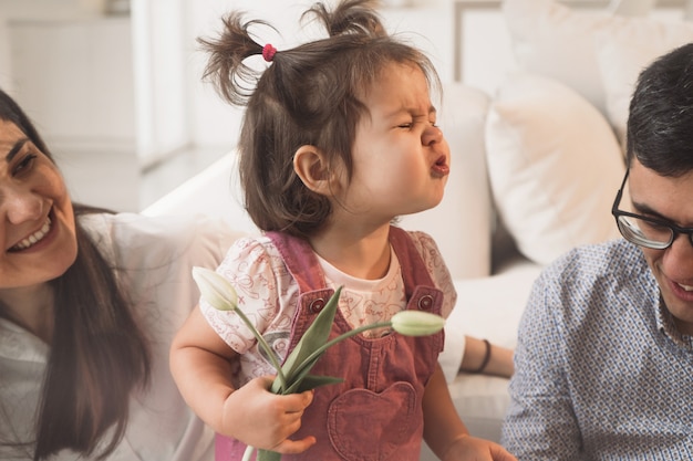 Naso Di Rughe Divertenti Per Bambini Ragazza Che Tiene Un Tulipano Foto Di Famiglia Calda Foto Premium