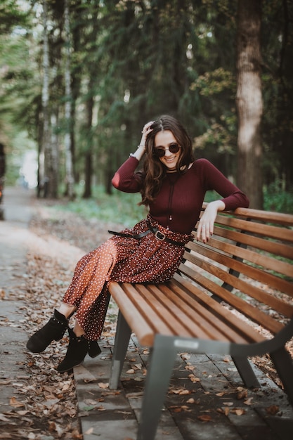 Bella Ragazza Seduta Nel Parco Su Una Panchina In Autunno Foto Premium 