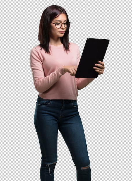 Jonge mooie vrouw glimlachend en zelfverzekerd, met een tablet, gebruiken om te surfen op het internet en sociale netwerken, communicatie te zien Premium Psd