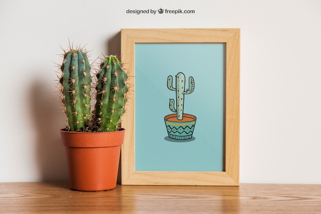 Download Mockup de marco con cactus | Archivo PSD Gratis