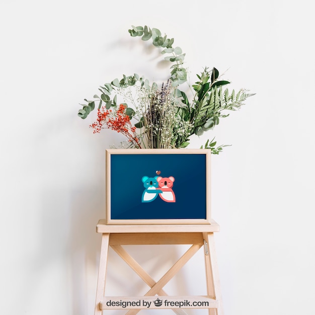 Download Mockup de marco en taburete con flores | Archivo PSD Gratis