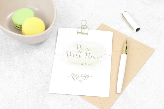 Cartão de convite de maquete com caneta e macarons Psd Premium