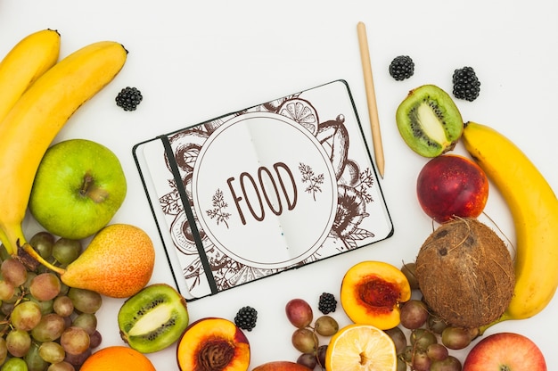 Maquete de livro aberto com frutas Psd grátis