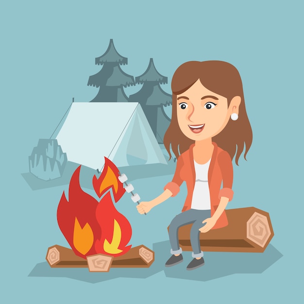 Fille caucasienne rôtir la guimauve sur le feu de camp. Vecteur Premium