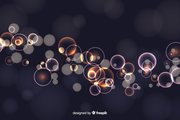 Fond de bokeh avec des particules d'or Vecteur gratuit