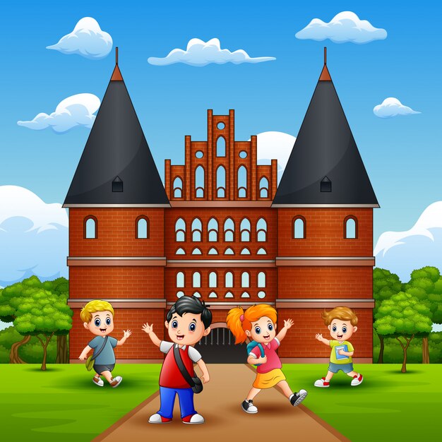 Joyeux écoliers joyeux et riant devant holstentor Vecteur Premium