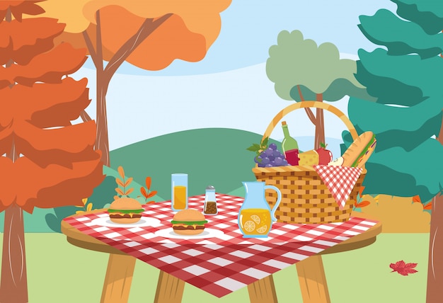 Panier avec bocal de jus d'orange et hamburger avec bouteille de vin Vecteur gratuit