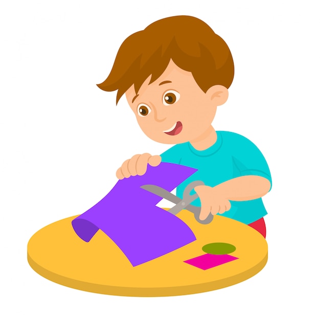 Niño está cortando papel de color con tijeras | Vector Premium