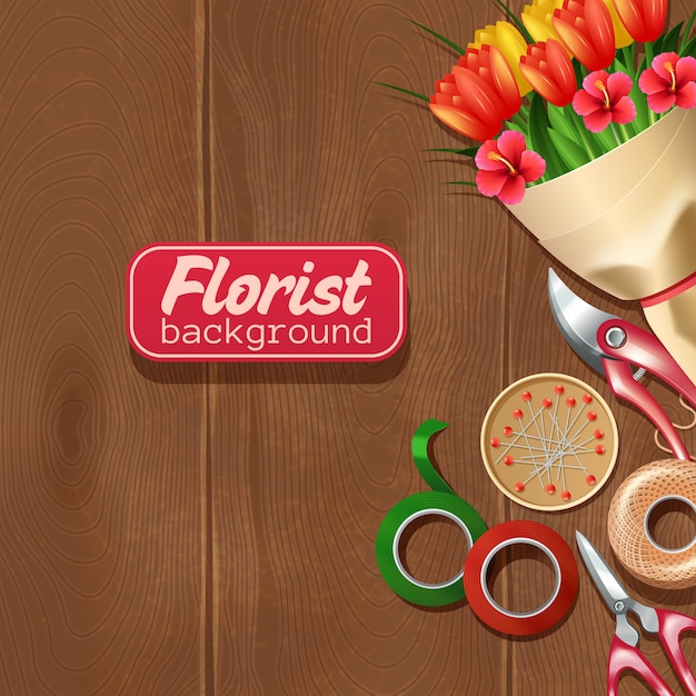 Bando de equipamentos e flores de florista em fundo de madeira Vetor grátis