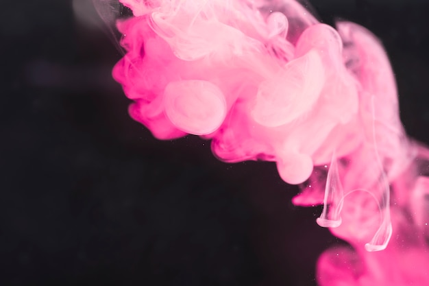 Artistieke krachtige roze rook op zwart scherm Gratis Foto