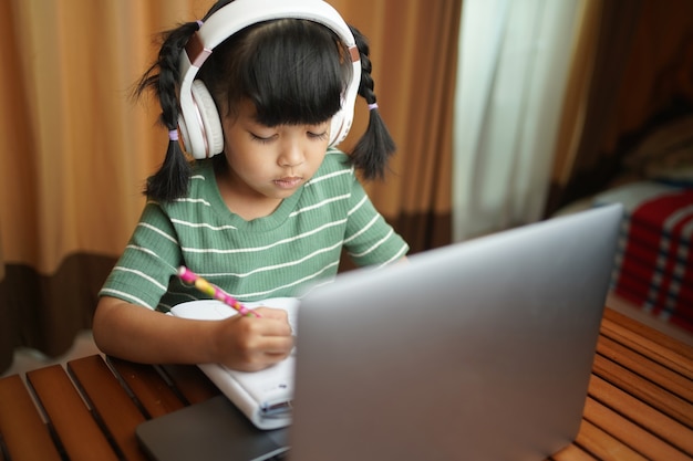 Aziatische jongen meisje school leerling koptelefoon studeren online vanuit huis kijken web klas les of luisteren tutor door | Premium Foto