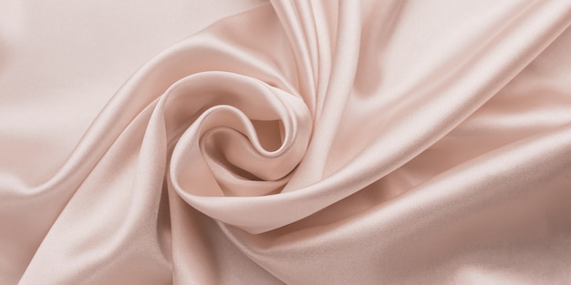 Voorvoegsel vervormen Aan boord Delicate gladde zacht roze zijden laken, abstracte stof achtergrond met  golven. | Premium Foto