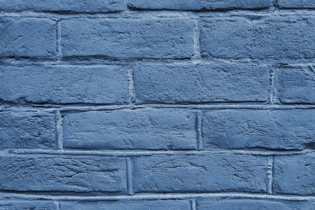 Gebarsten en getextureerde blauwe muur, bakstenen muur achtergrond