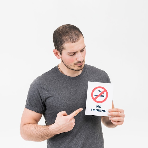 Jonge mens die haar vinger naar niet rokend teken richt dat op witte achtergrond wordt geïsoleerd Gratis Foto