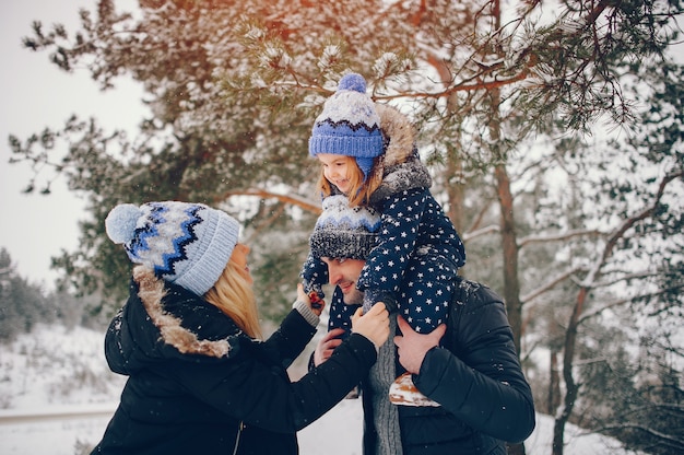 Meisje met ouders die in een de winterpark spelen Gratis Foto