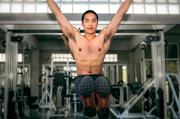 Afgrond werk Uitwisseling Sterke bodybuilder atletische aziatische man training oefening buikspier  (l-sit) op de balk op fitness gym. | Premium Foto