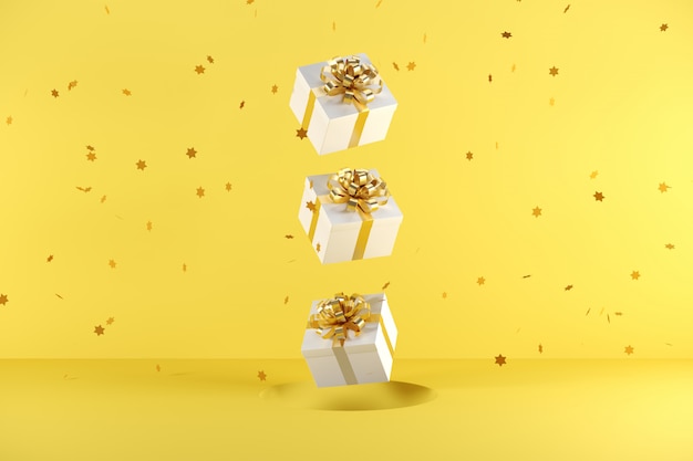 Witte geschenkdoos met gouden lint kleur drijvend op gele achtergrond Premium Foto