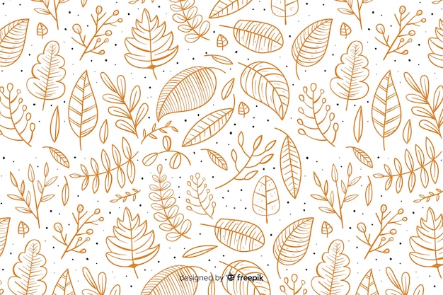 Hand getrokken herfst achtergrond met bladeren Gratis Vector