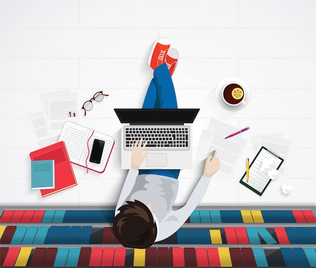 Man zit op de vloer in de bibliotheek Premium Vector