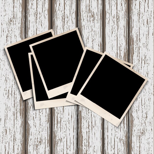 Oude fotolijsten op oude houten achtergrond Premium Vector